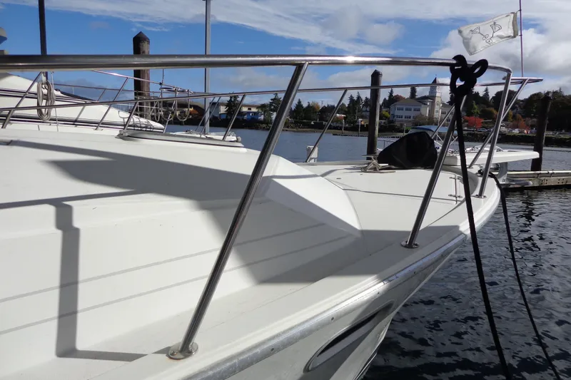 Slide: The Image of 1992 Bayliner 3288 Motoryacht docked, showcasing sleek deck and railing design. - 7