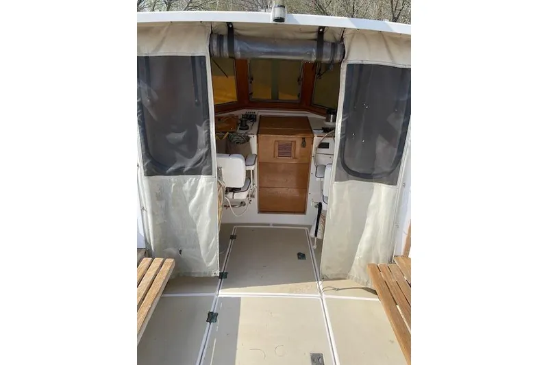 Slide: The Image of 1986 Cape Dory MS300 boat interior with wooden cabinetry and seating. - 3