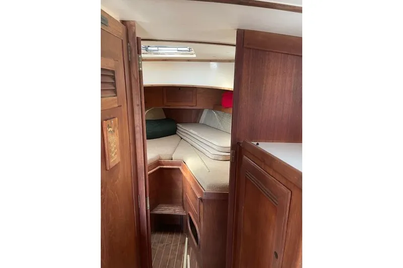 Slide: The Image of Interior cabin of 1986 Cape Dory MS300 sailboat with wooden finish and cozy sleeping area. - 6