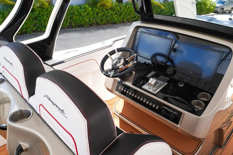 Slide: The Image of 2023 Renegade 38 GTS Open boat cockpit with dual screens and luxury seating. - 18