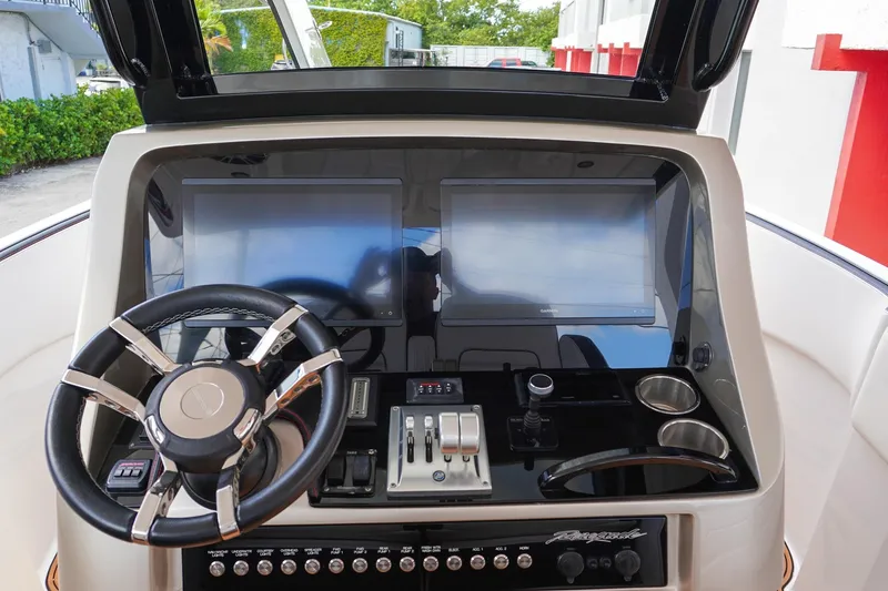 Slide: The Image of 2023 Renegade 38 GTS Open dashboard with dual screens and modern controls. - 19