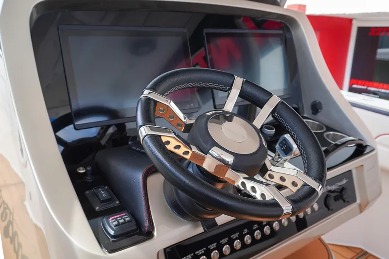 Slide: The Image of Steering wheel and dashboard of 2023 Renegade 38 GTS Open boat. - 21
