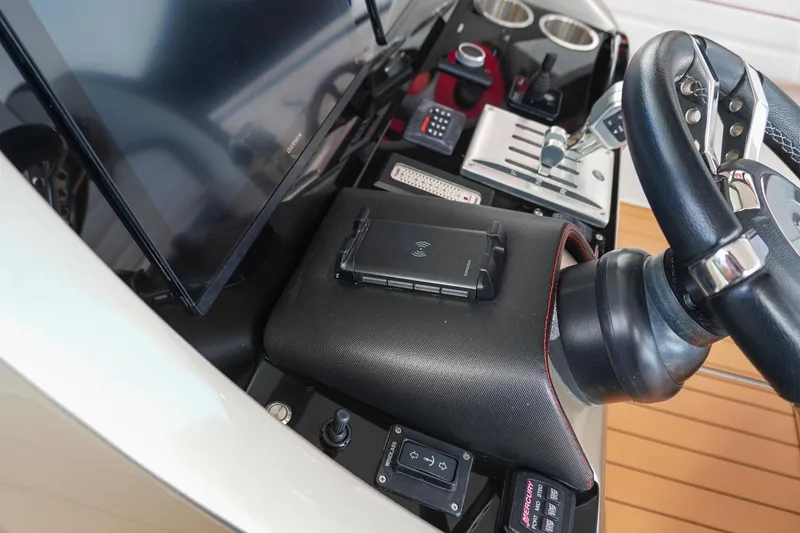 Slide: The Image of 2023 Renegade 38 GTS Open dashboard with steering wheel, controls, and display screen. - 22