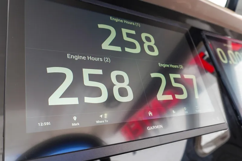 Slide: The Image of Garmin display showing engine hours on 2023 Renegade 38 GTS Open boat. - 38
