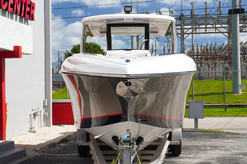 Slide: The Image of 2023 Renegade 38 GTS Open boat on trailer, front view, outdoors. - 5