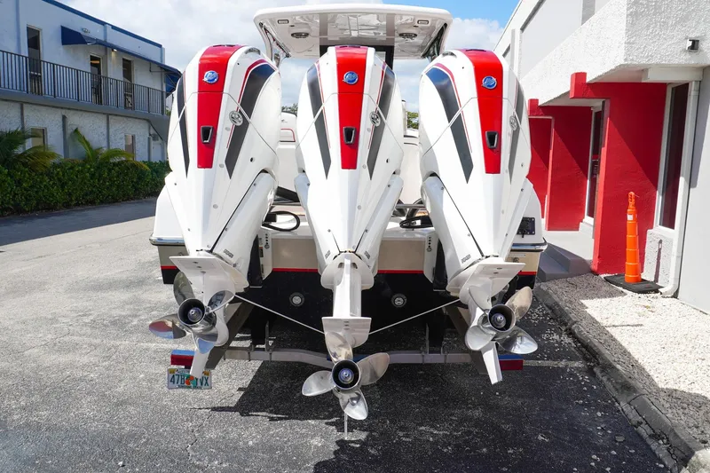 Slide: The Image of 2023 Renegade 38 GTS Open with triple outboard engines, rear view. - 8