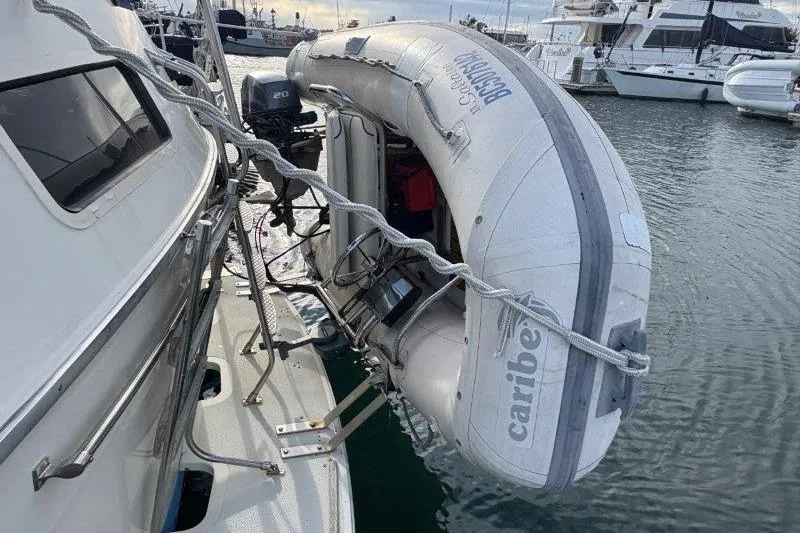 Slide: The Image of 1987 Tollycraft 34 Sundeck Motor Yacht with attached inflatable dinghy in marina. - 11