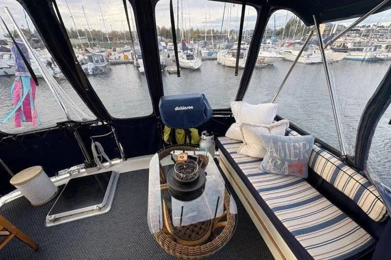 Slide: The Image of 1987 Tollycraft 34 Sundeck Motor Yacht interior with cozy seating and marina view. - 14