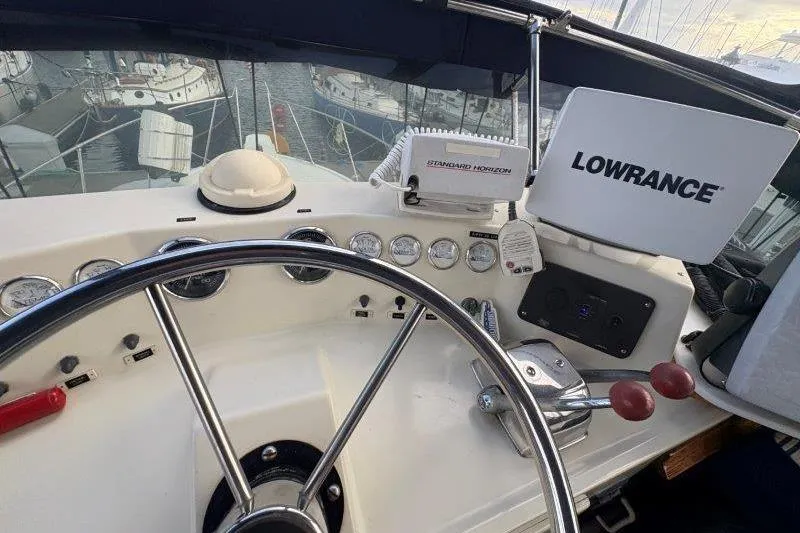Slide: The Image of 1987 Tollycraft 34 Sundeck Motor Yacht helm with navigation equipment and steering wheel. - 23