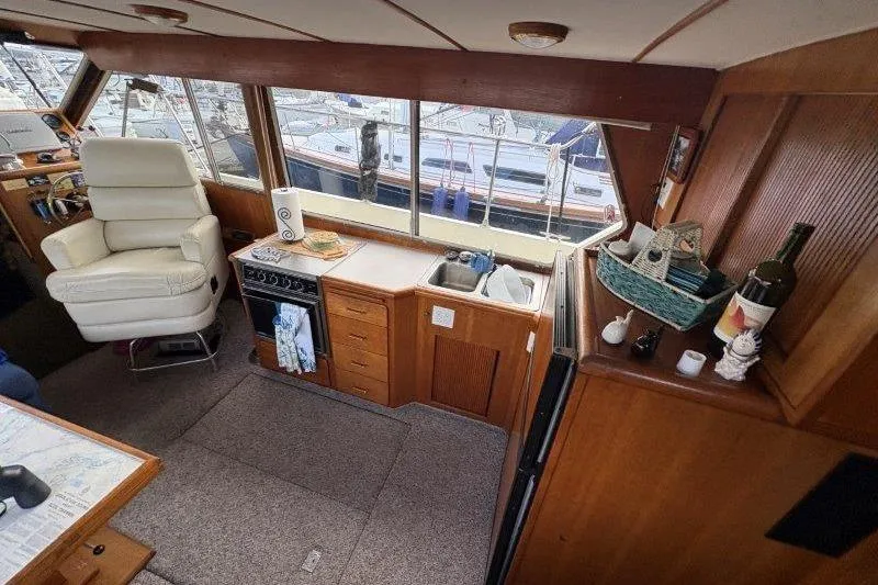 Slide: The Image of Interior of 1987 Tollycraft 34 Sundeck Motor Yacht with kitchen and seating area. - 25