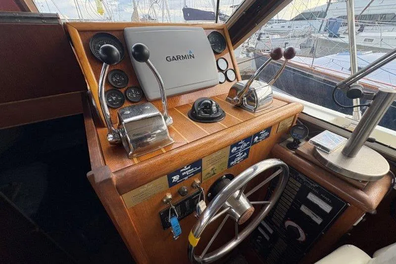 Slide: The Image of 1987 Tollycraft 34 Sundeck Motor Yacht helm with Garmin navigation system and controls. - 27