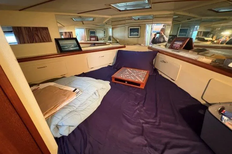 Slide: The Image of Interior of 1987 Tollycraft 34 Sundeck Motor Yacht with cozy bedding and decor. - 33
