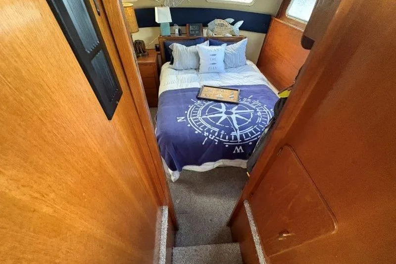 Slide: The Image of Cozy bedroom in 1987 Tollycraft 34 Sundeck Motor Yacht with nautical decor. - 38