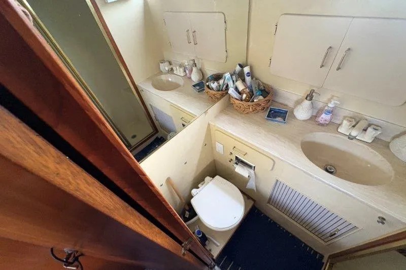 Slide: The Image of 1987 Tollycraft 34 Sundeck Motor Yacht bathroom with dual sinks and storage cabinets. - 47