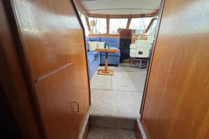 Slide: The Image of Interior of 1987 Tollycraft 34 Sundeck Motor Yacht with blue seating and wooden accents. - 48