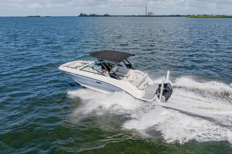 Slide: The Image of 2021 Sea Ray SDX 250 Outboard cruising on open water, showcasing sleek design and performance. - 14