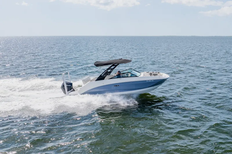 Slide: The Image of 2021 Sea Ray SDX 250 Outboard cruising on open water under clear skies. - 15