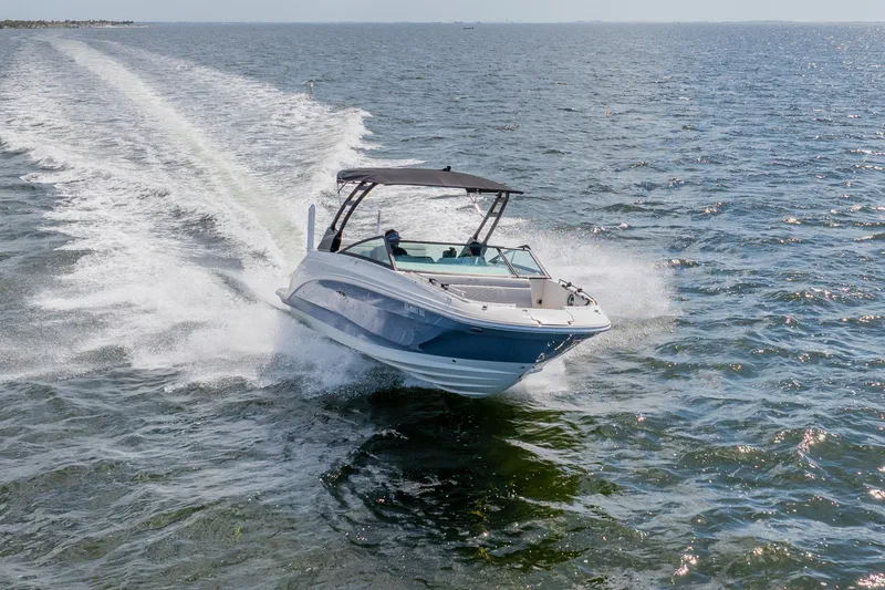 Slide: The Image of 2021 Sea Ray SDX 250 Outboard cruising on open water, creating a dynamic wake. - 16