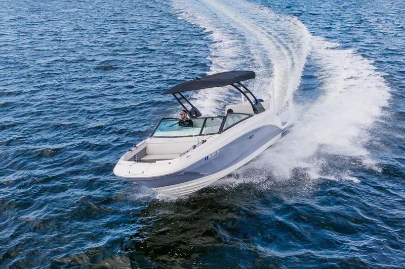 Slide: The Image of 2021 Sea Ray SDX 250 Outboard cruising on open water, creating a dynamic wake. - 18