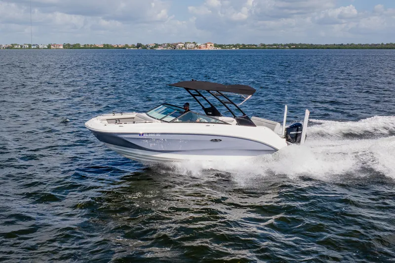 Slide: The Image of 2021 Sea Ray SDX 250 Outboard cruising on open water under a clear sky. - 20