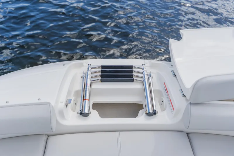 Slide: The Image of 2021 Sea Ray SDX 250 Outboard swim platform with retractable ladder on water. - 22