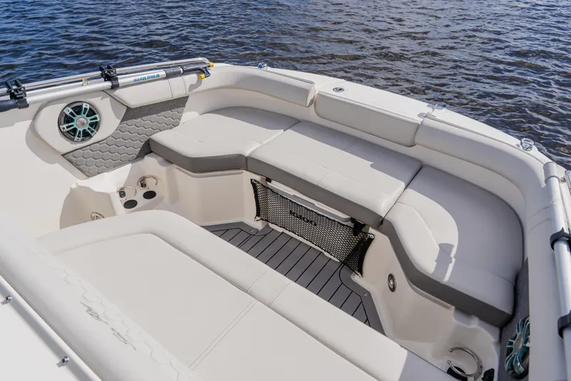 Slide: The Image of 2021 Sea Ray SDX 250 Outboard boat interior with spacious seating and water backdrop. - 25