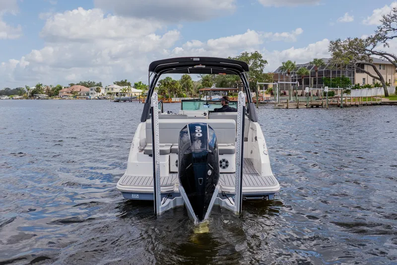 Slide: The Image of 2021 Sea Ray SDX 250 Outboard boat cruising on a scenic waterway. - 3