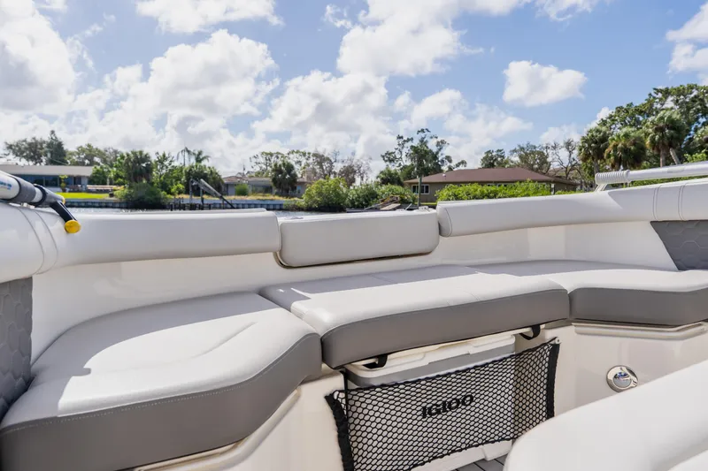 Slide: The Image of 2021 Sea Ray SDX 250 Outboard boat interior with cushioned seating and scenic background. - 32