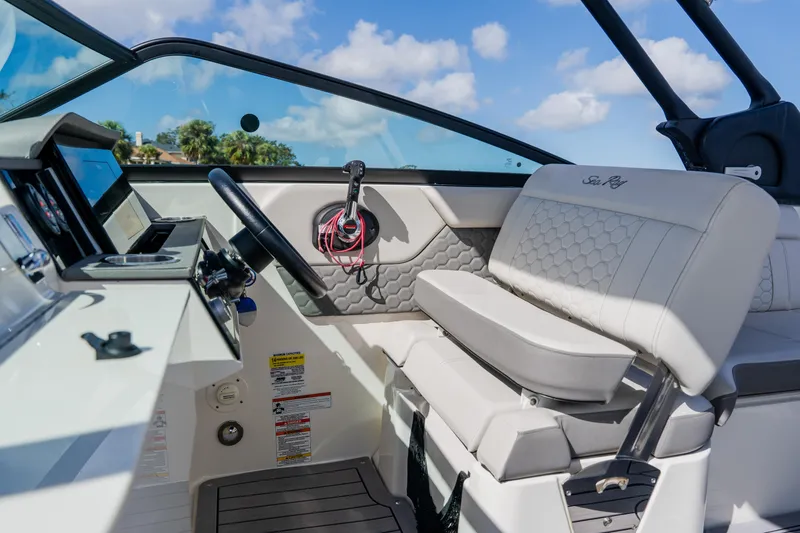 Slide: The Image of 2021 Sea Ray SDX 250 Outboard boat interior with steering wheel and seating. - 39