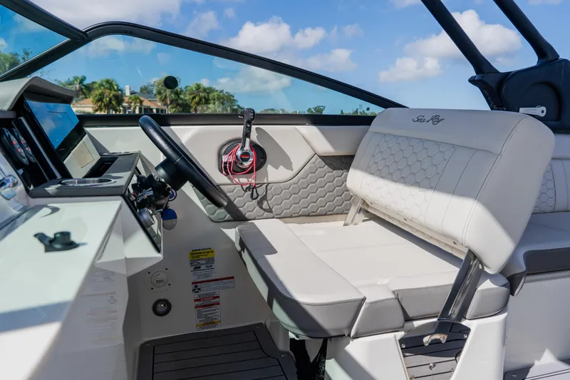 Slide: The Image of 2021 Sea Ray SDX 250 Outboard boat interior with steering wheel and seating. - 41