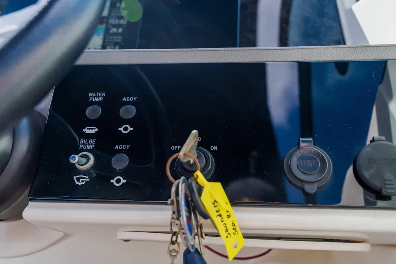 Slide: The Image of Control panel of 2021 Sea Ray SDX 250 Outboard with ignition keys and switches. - 45