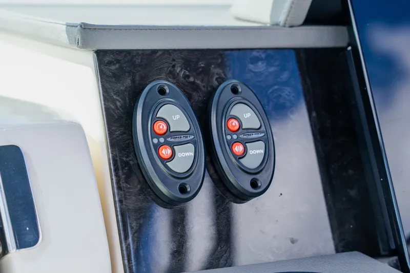 Slide: The Image of Control panel on 2021 Sea Ray SDX 250 Outboard boat, featuring up and down buttons. - 46