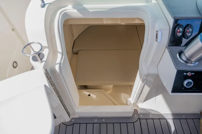 Slide: The Image of 2021 Sea Ray SDX 250 Outboard interior cabin with seating and control panel. - 47