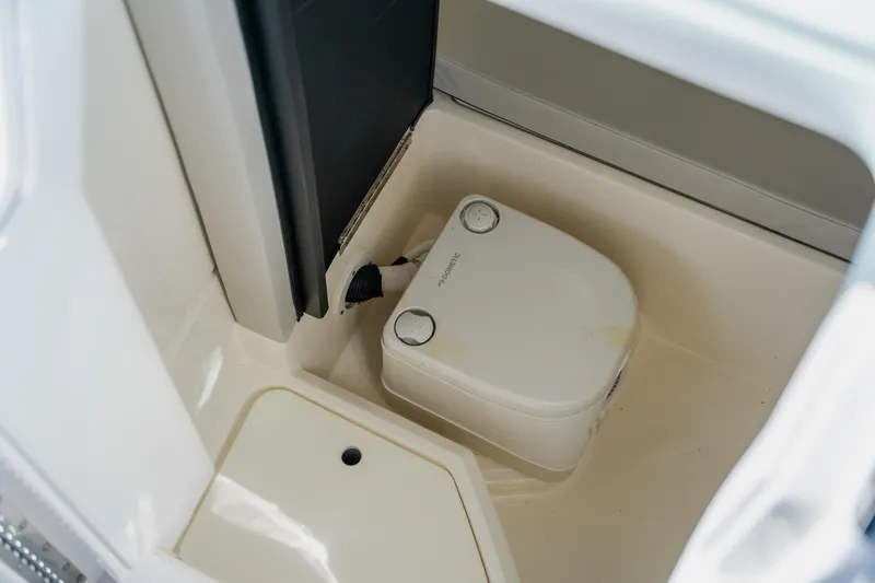 Slide: The Image of 2021 Sea Ray SDX 250 Outboard boat interior with compact marine toilet. - 49