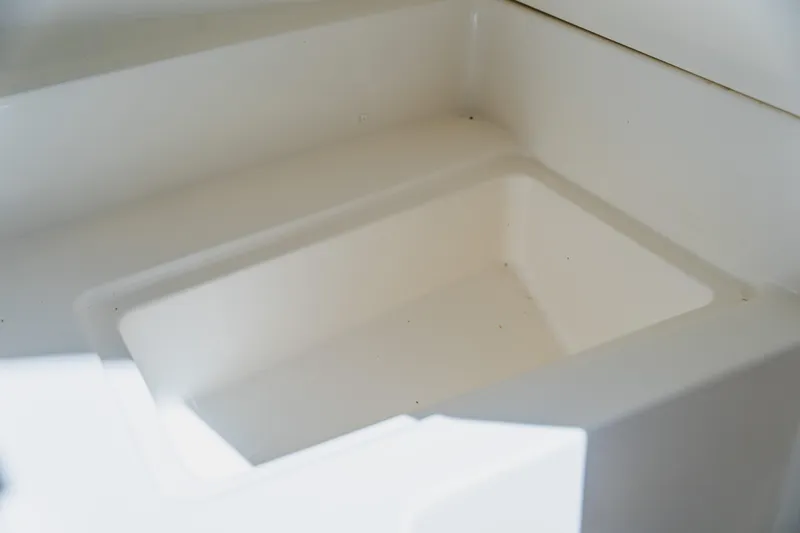 Slide: The Image of 2021 Sea Ray SDX 250 Outboard storage compartment, white interior detail. - 52