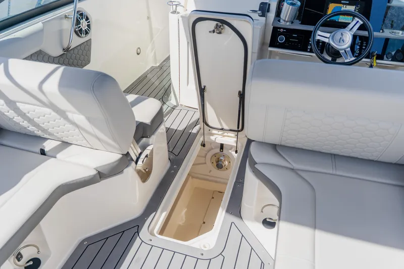 Slide: The Image of 2021 Sea Ray SDX 250 Outboard interior with seating and storage compartment. - 57