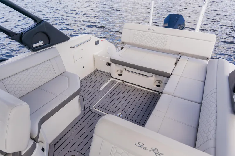 Slide: The Image of 2021 Sea Ray SDX 250 Outboard boat interior with luxurious seating and water backdrop. - 59