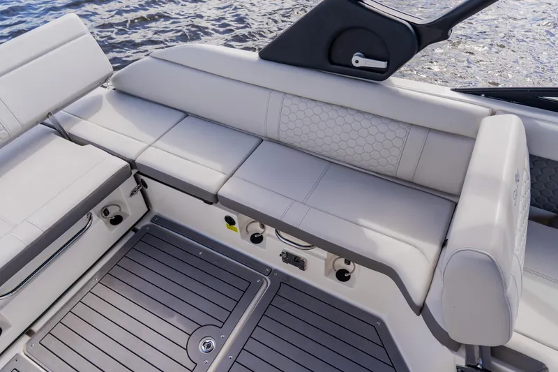 Slide: The Image of 2021 Sea Ray SDX 250 Outboard boat interior with cushioned seating and sleek design. - 62