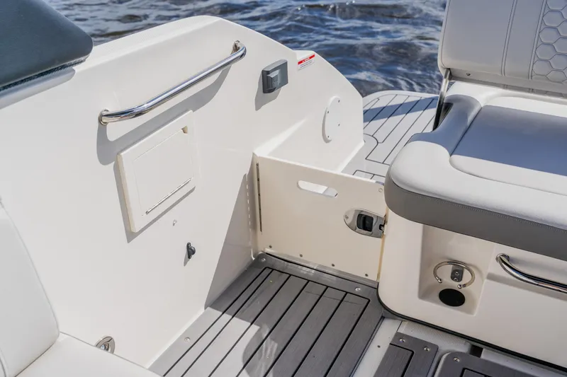 Slide: The Image of 2021 Sea Ray SDX 250 Outboard boat interior with seating and deck details. - 70