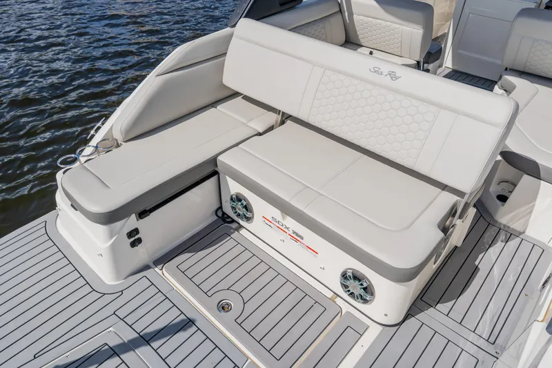 Slide: The Image of 2021 Sea Ray SDX 250 Outboard boat interior with cushioned seating and water view. - 72