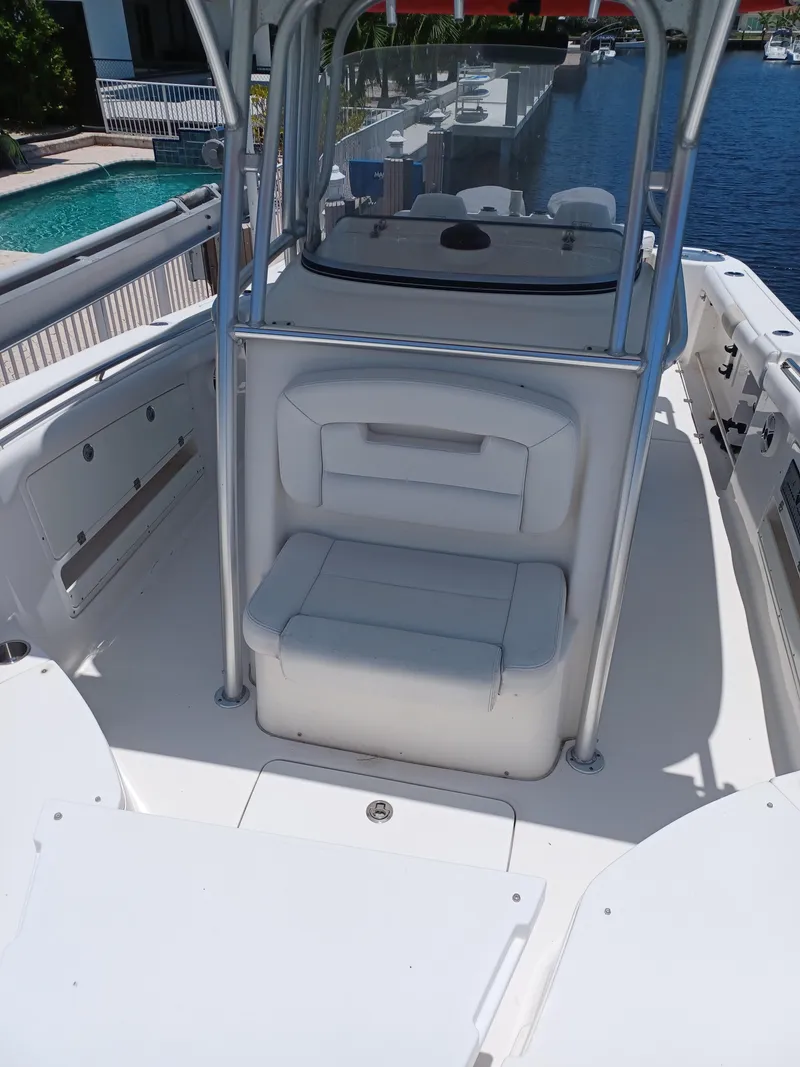 Slide: The Image of 2016 Robalo R300 Center Console boat interior with seating and console. - 12