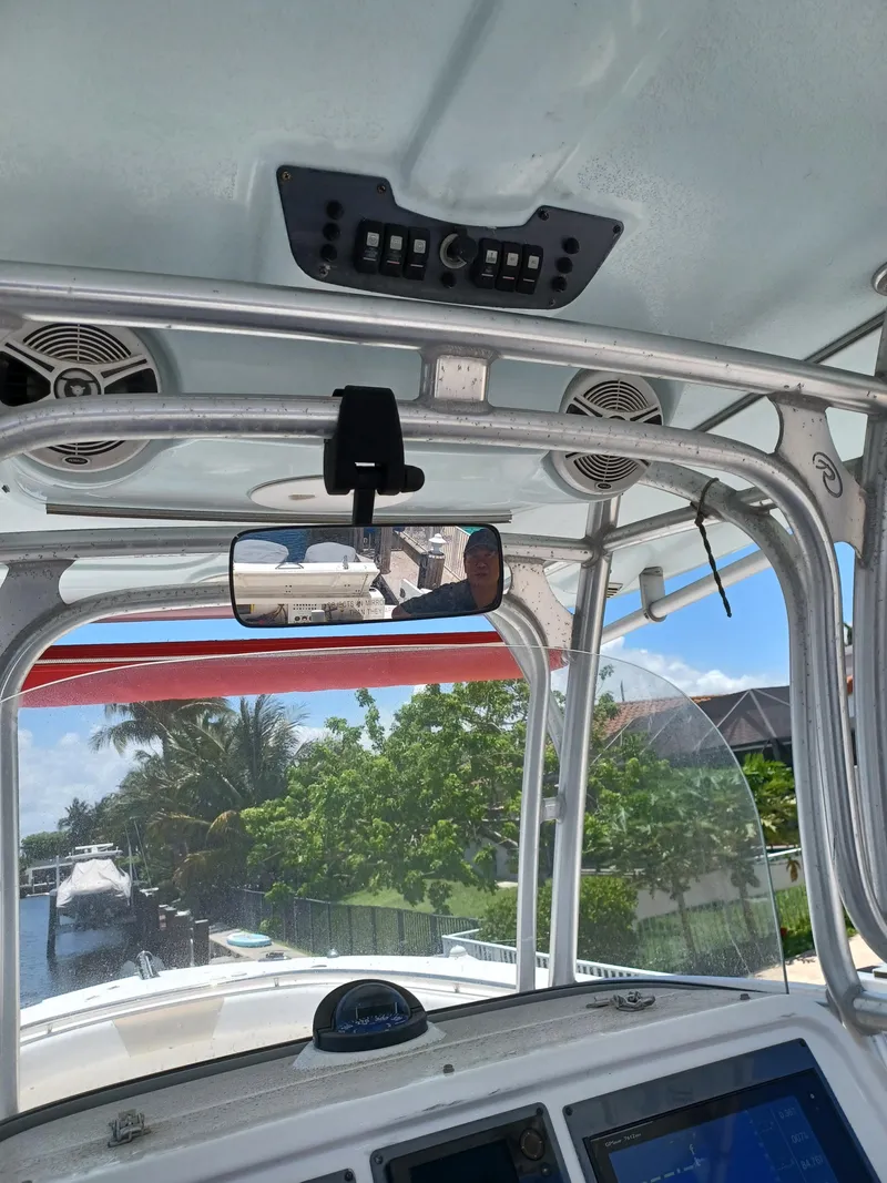 Slide: The Image of 2016 Robalo R300 Center Console boat interior with electronics and view of the water. - 13