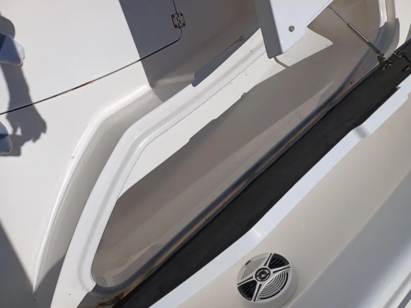 Slide: The Image of 2016 Robalo R300 Center Console storage compartment and speaker. - 16