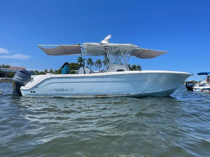 Slide: The Image of 2016 Robalo R300 Center Console boat on water with blue sky background. - 2