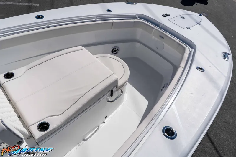 Slide: The Image of 2026 Sea Hunt Ultra 305 Coffin Box boat interior with cushioned seating and cup holders. - 19