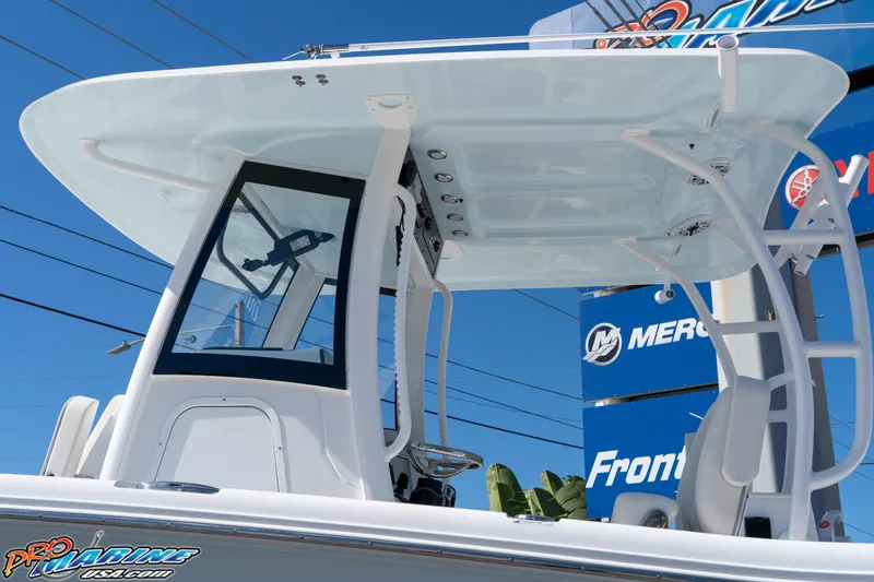 Slide: The Image of 2026 Sea Hunt Ultra 305 Coffin Box boat with T-top and console, displayed outdoors. - 21