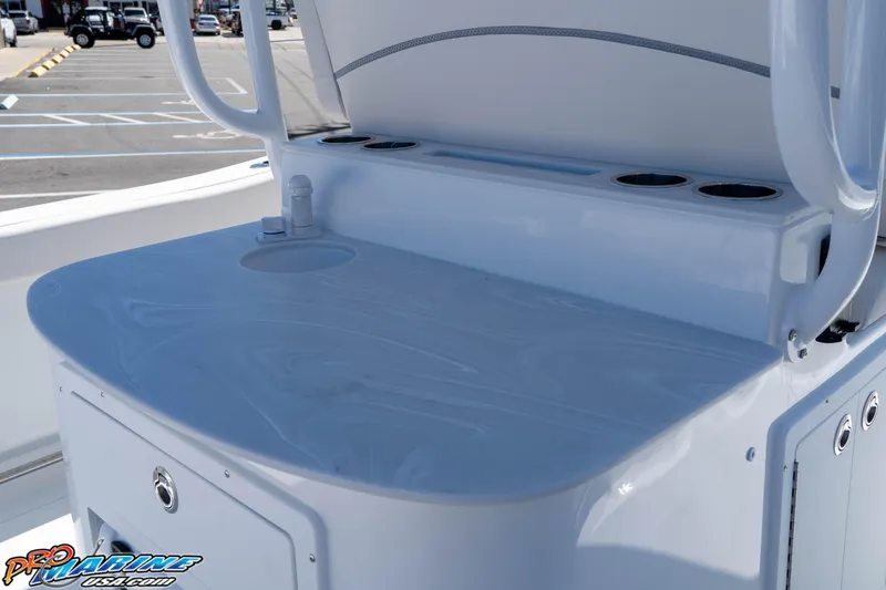Slide: The Image of 2026 Sea Hunt Ultra 305 Coffin Box boat console with cup holders and sink. - 28