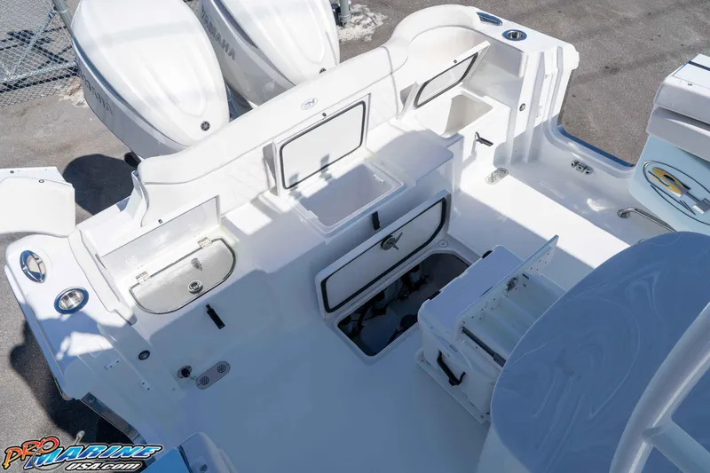 Slide: The Image of 2026 Sea Hunt Ultra 305 Coffin Box boat interior with storage compartments and Yamaha engines. - 31