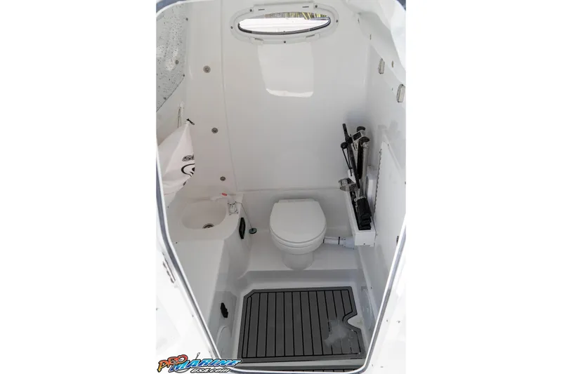 Slide: The Image of Interior of 2026 Sea Hunt Ultra 305 Coffin Box boat bathroom with toilet and sink. - 32