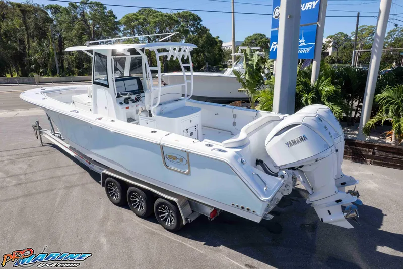 Slide: The Image of 2026 Sea Hunt Ultra 305 Coffin Box boat with Yamaha engines on a trailer. - 4